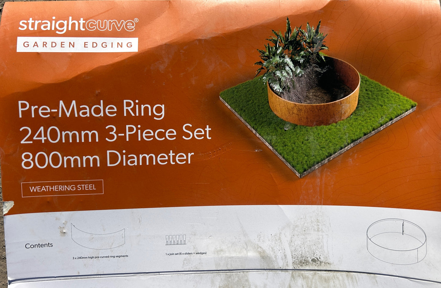 Straight Curve garden edging packaging with a pre-made ring on an orange background
