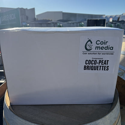 White box with Coir Media label on a wooden barrel outdoors