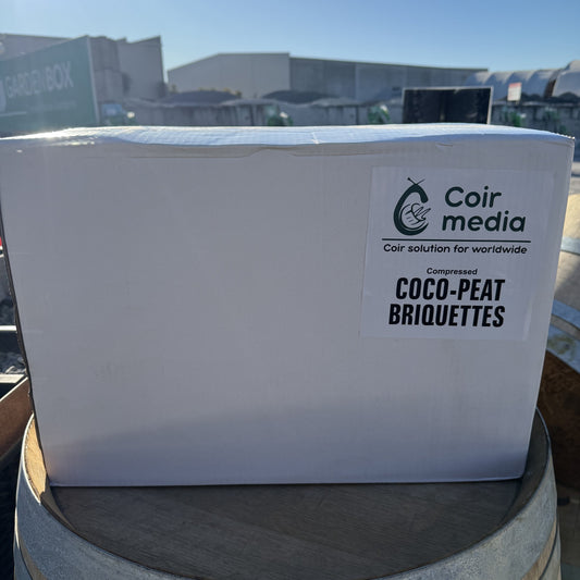 White box with Coir Media label on a wooden barrel outdoors