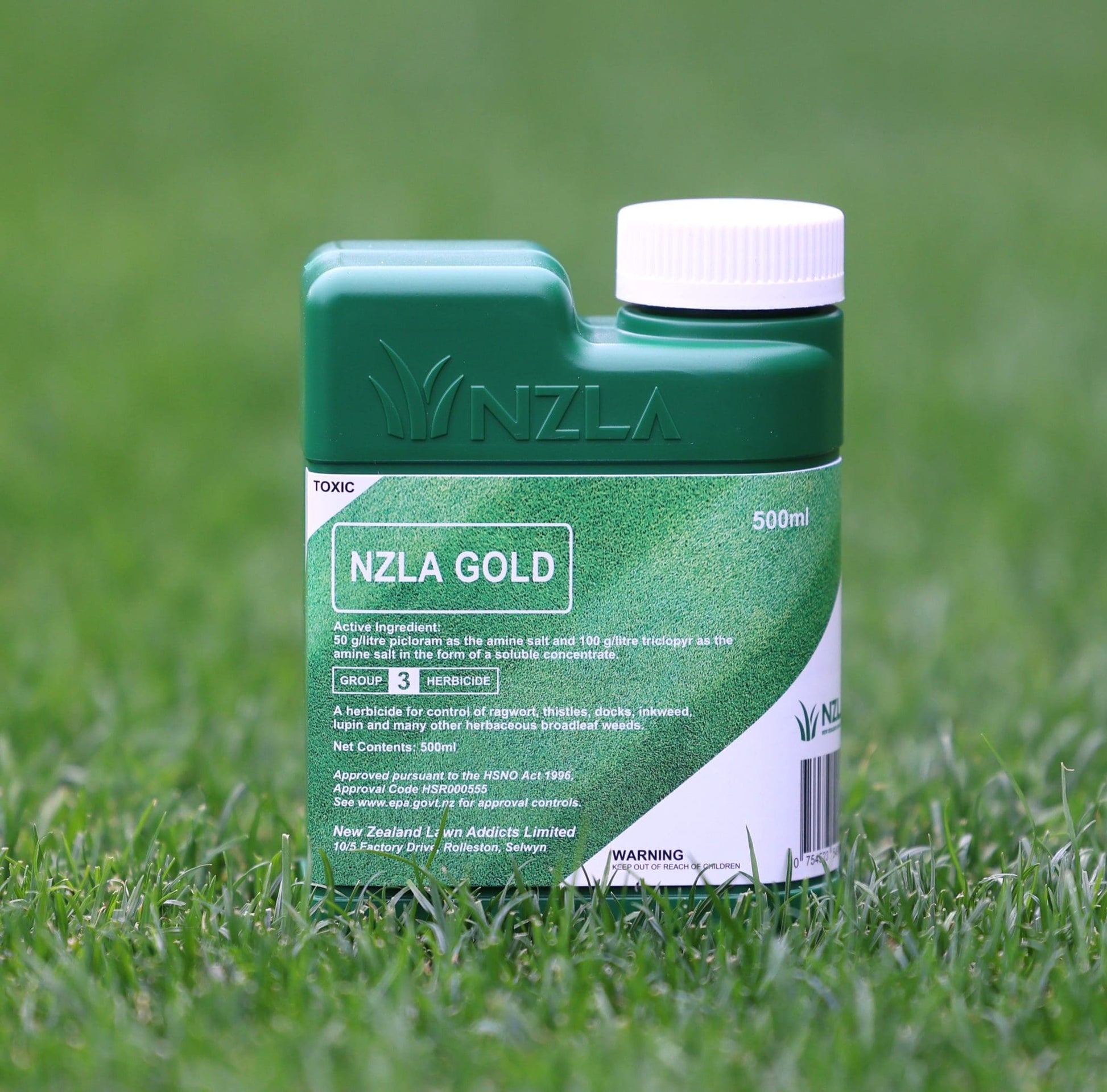 NZLA Gold bottle on grass