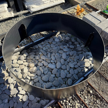 Metal ring with stones inside on a gravel surface